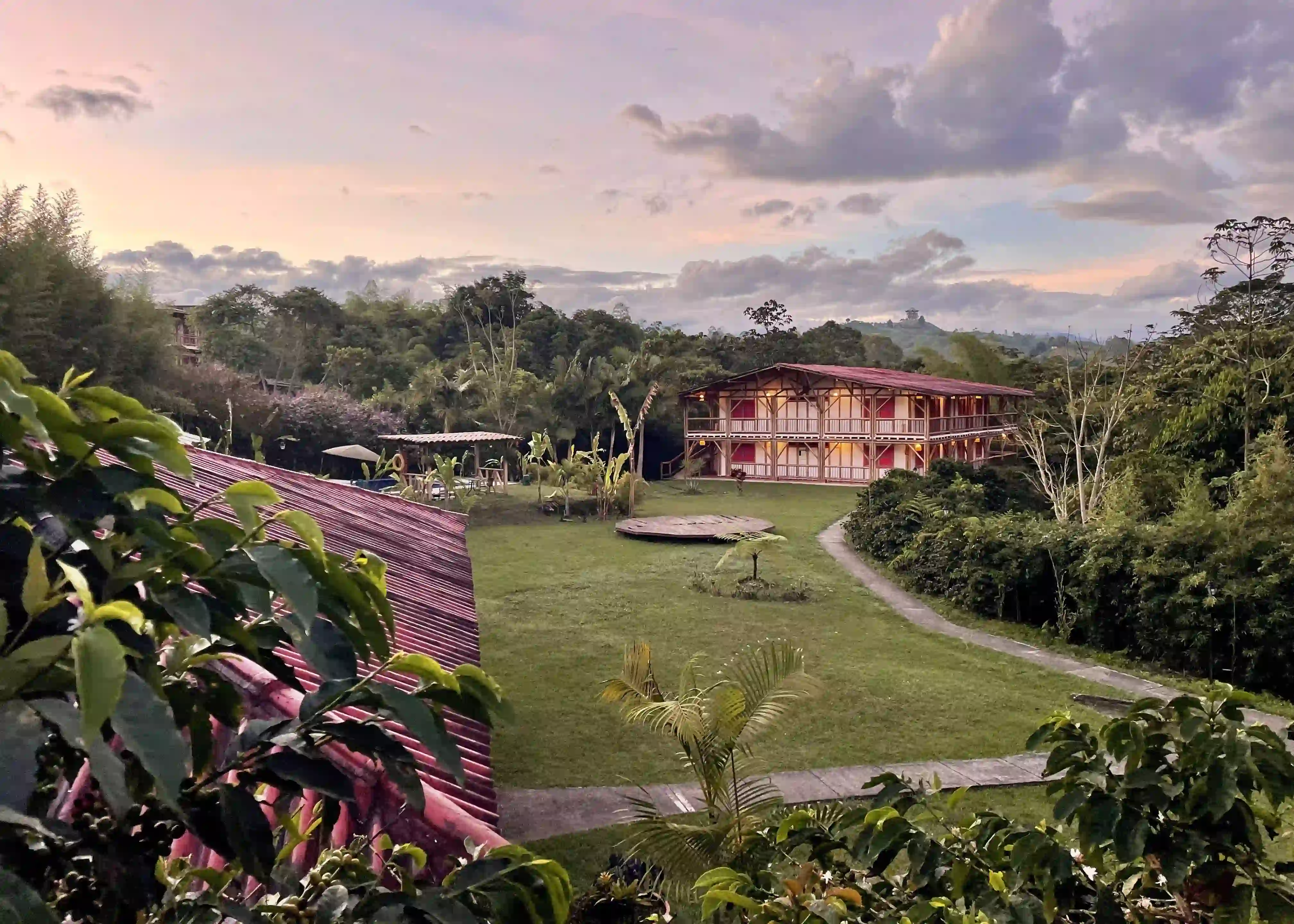 MuchoSur Filandia Nature Lodge exterior with pool among native trees and traditional coffee-region architecture